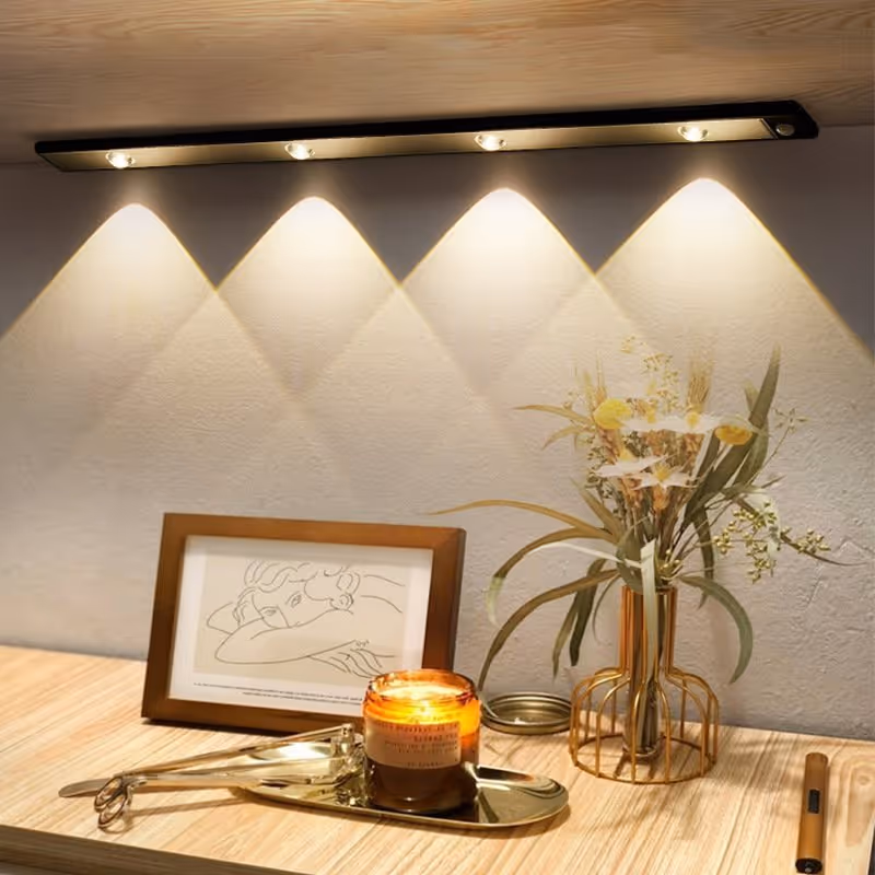 LED motion sensor cabinet light illuminating a dark interior